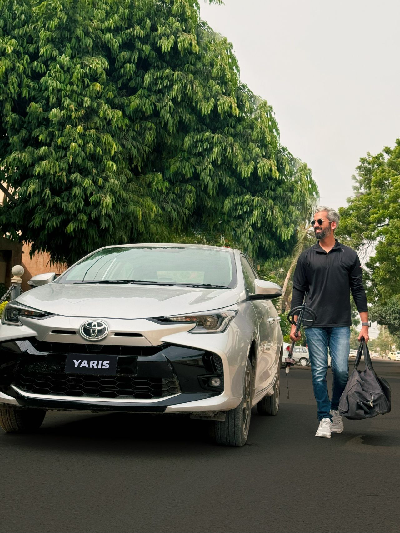 Sameer Ahmed Khan with the Toyota Yaris and spearfishing gear in Karachi